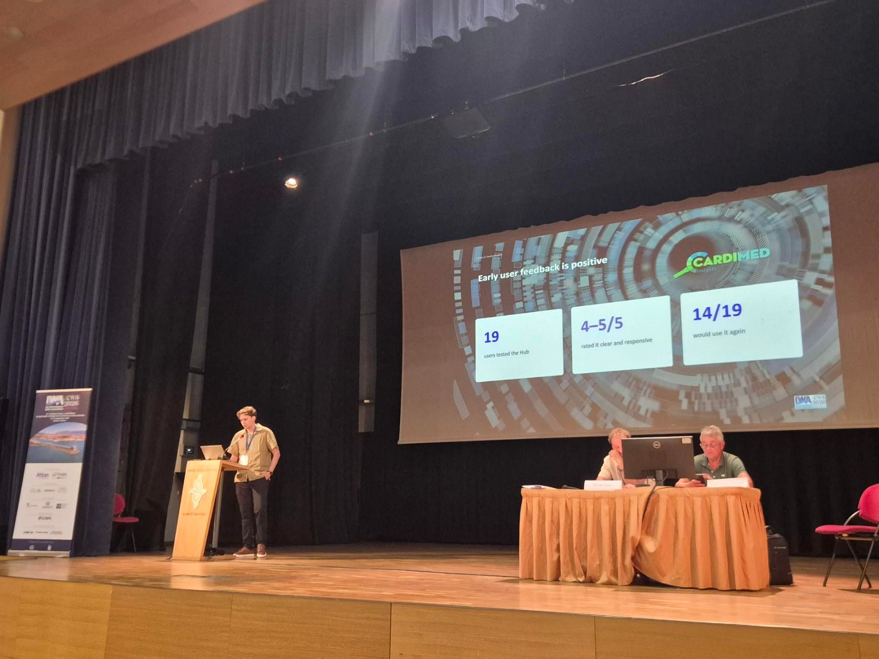 Konstantinos Kaimakis presenting CARDIMED Insights Hub user-testing results on stage at ICWS 2026