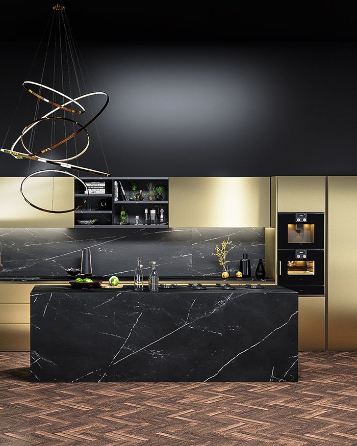 This image captures the refined and modern aesthetic of a GOLDNESS kitchen by Mebel Arts, featuring a prominent kitchen island with a marble surface. The design is contemporary, with clean lines and gold accents that add a touch of luxury. The smart placement of built-in appliances and open shelving offers both functionality and style. The art piece on the wall and subtle lighting installation enhance the ambiance and accentuate the space's luxury.