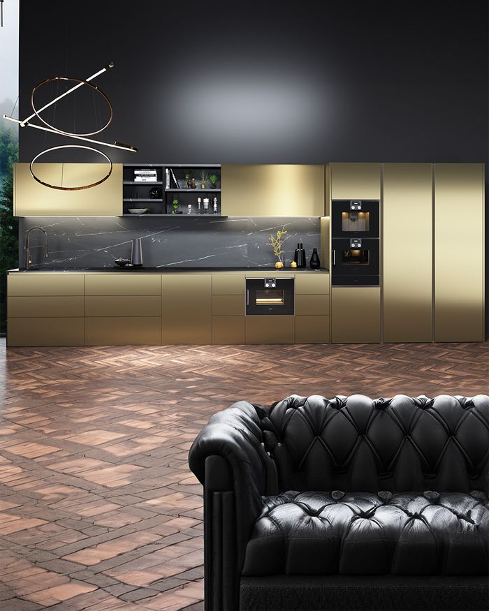 This image presents a luxurious GOLDNESS kitchen by Mebel Arts, featuring a marble front that, together with the striking decor, creates a sense of flow and spaciousness. The combination of the gold-colored cabinets with the black marble adds an understated opulence. The meticulous lighting installation above the kitchen island enhances the aesthetic and atmosphere of the space. The image conveys the functionality and adaptability of the kitchen, making it ideal for a modern lifestyle.