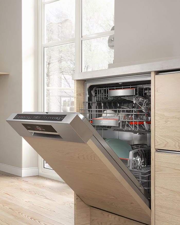 Discover the advanced built-in dishwasher from Mebel Arts, perfect for modern kitchens. This luxurious dishwasher is designed to seamlessly integrate with your kitchen cabinets, offering efficient cleaning and space-saving features. The photo shows the dishwasher with an open door, revealing its detailed interior shelves and equipment, which perfectly complement a bright space with natural light. Its modern design and durable construction ensure the performance and aesthetics demanded by our customers.