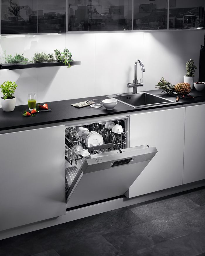 The sophisticated built-in white dishwasher from Mebel Arts represents the perfect combination of luxury and functionality in kitchen design. The image showcases the high-tech interior of the dishwasher, ready to accommodate your dishes and utensils in harmony with the minimalist and clean design of a modern kitchen. Mebel Arts' contribution to aesthetics and practicality is evident, making this dishwasher an ideal choice for those seeking seamless integration and performance.