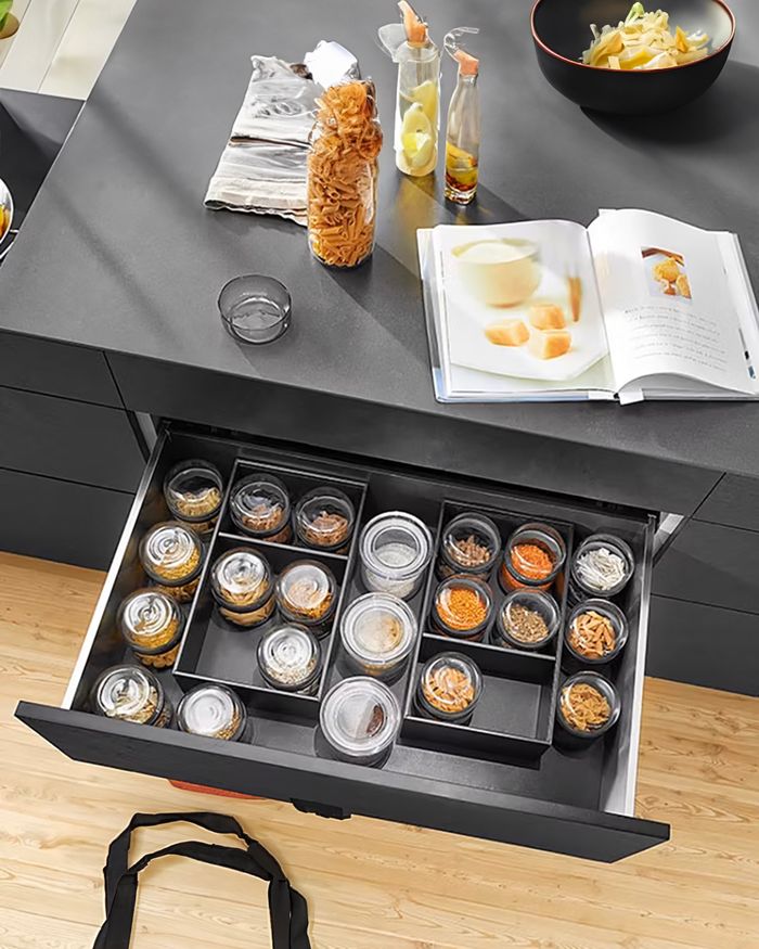 Spice storage with the Ambia Line divider system from BLUM by Mebel Arts for a practical kitchen.