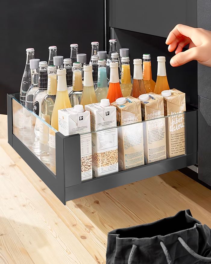 Spacious Mebel Arts Legrabox Free drawer filled with drinks and cereals, combining comfort and style.