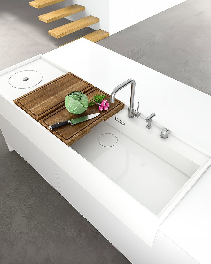 Modern Corian sink on a white island in the Mebel Arts Tamo kitchen.