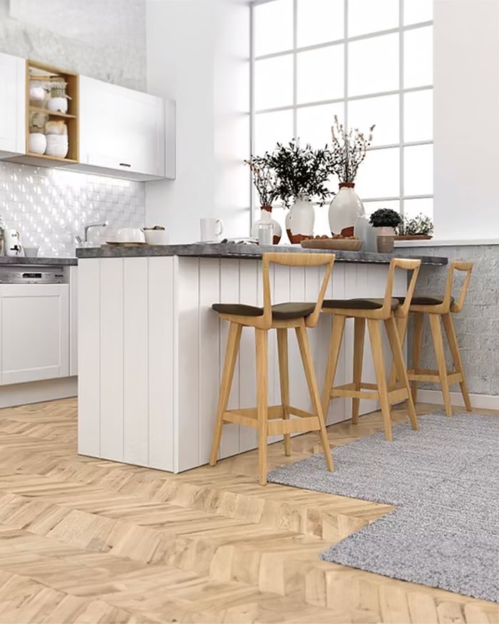 Modern Mebel Arts kitchen in Scandinavian style, with white cabinets and wooden chairs.