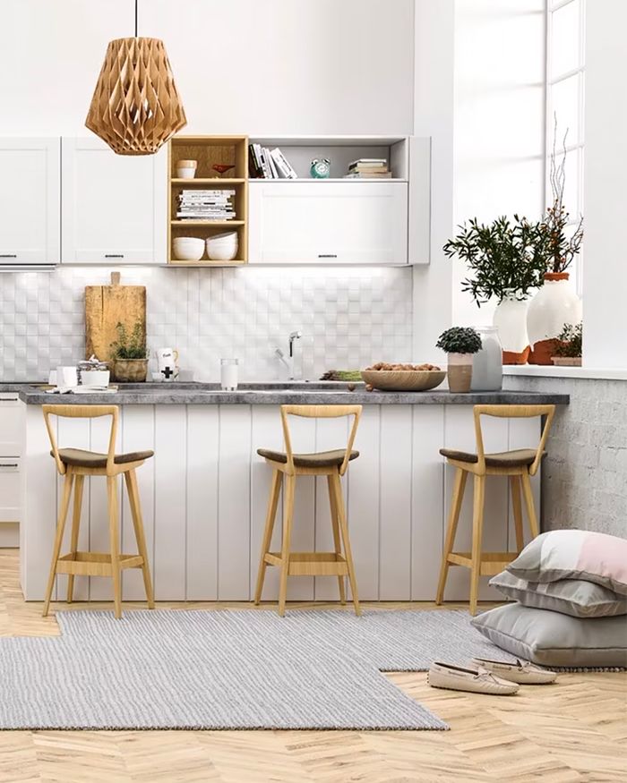 Bright Scandinavia kitchen by Mebel Arts with bar stools and a modern light fixture.