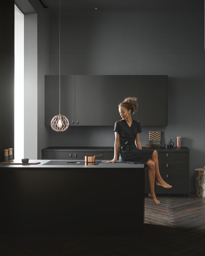 Stylish Mebel Arts kitchen with BORA X PURE cooktop and copper utensils, epitomizing contemporary aesthetics.