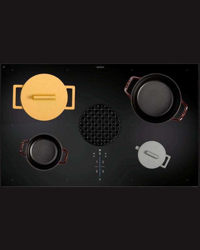 Combine functionality and style with the BORA X PURE cooktop and colorful Mebel Arts cookware.