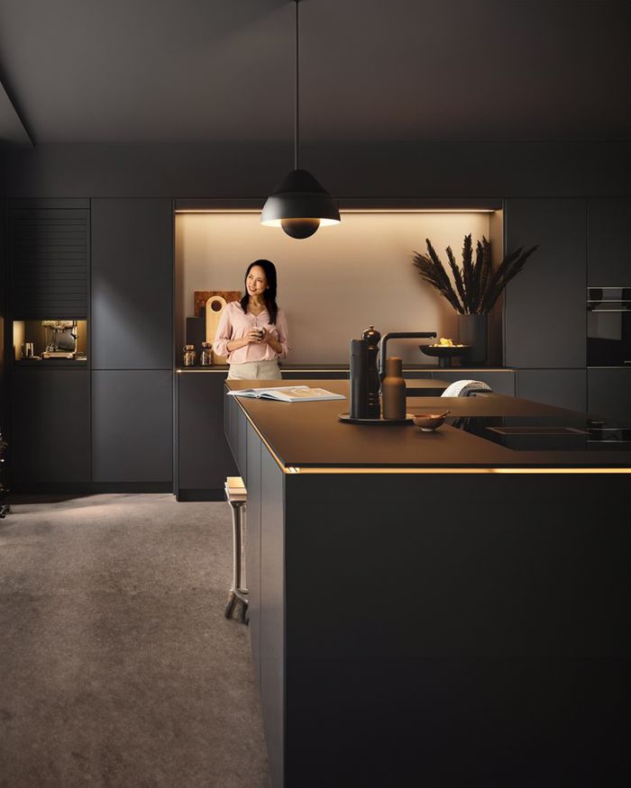 Modern Mebel Arts kitchen with Gola handle and LED lighting, providing a warm and stylish feel to the space.