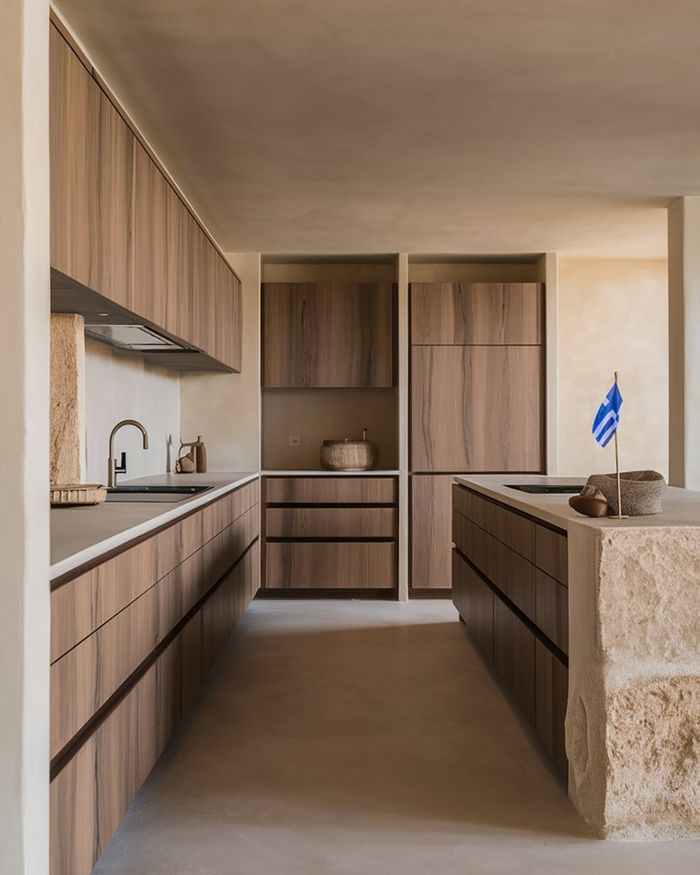 Modern Greek kitchen furniture in natural walnut wood tones with an embossed stone countertop.