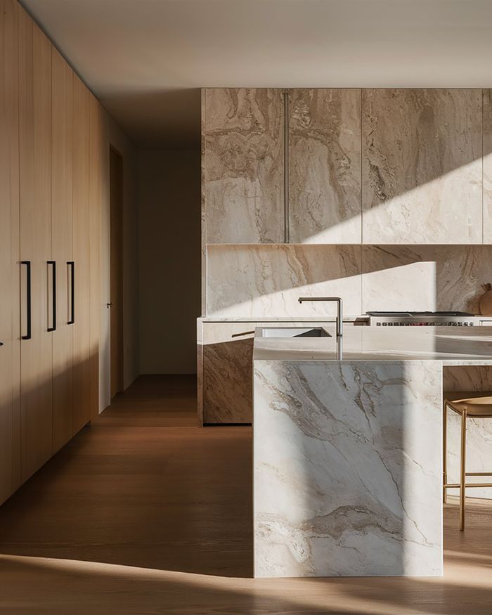 A luxurious kitchen with furniture adorned with marble. The minimal design and the elegance of marble create a sophisticated and modern space.