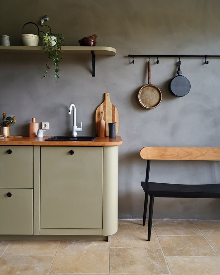 Kitchen furniture in Athens with a retro design, featuring green cabinets and a wooden countertop. Details include utensils and decorative elements by Mebel Arts.