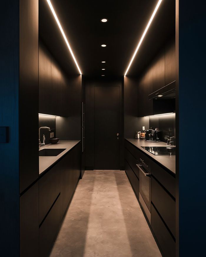 Kitchen furniture in Athens in black, modern design with integrated lighting. Simple and luxurious décor that emphasizes functionality by Mebel Arts.