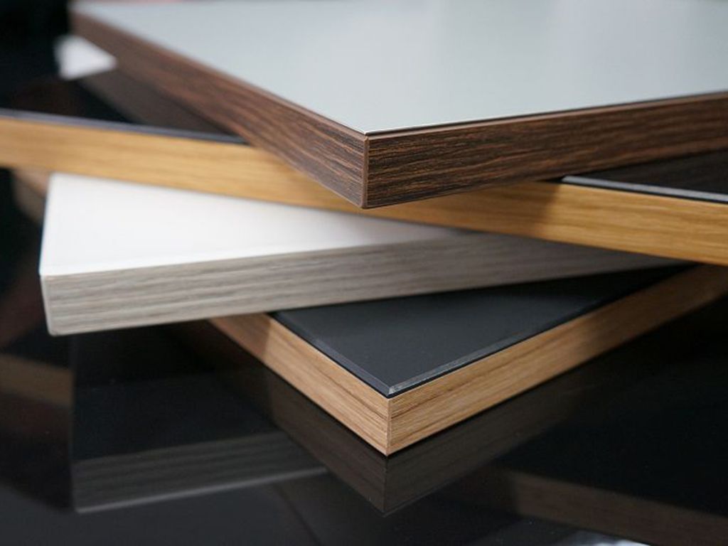 Cabinet material samples showing contrasting pale, dark and woodgrain surfaces