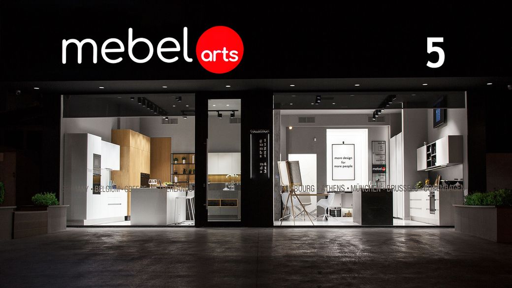 Kitchen furniture exhibition on Vouliagmenis Avenue by Mebel Arts, featuring an illuminated showcase and modern kitchens.