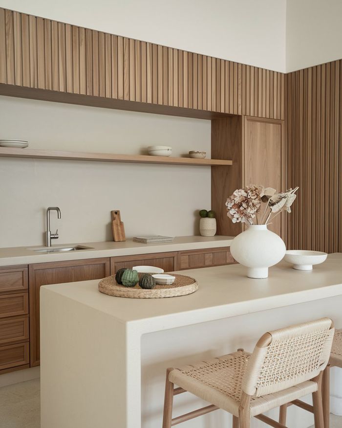 Wooden details and a modern white Corian island are elements that make the best kitchens stand out.